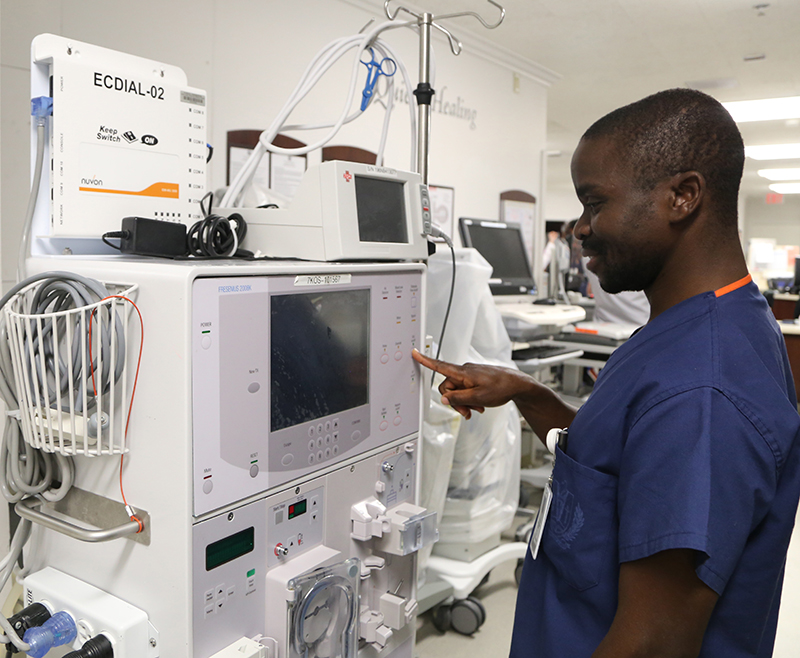 Felix Batson, RN, marvels at a dialysis machine, a device he has only read about.