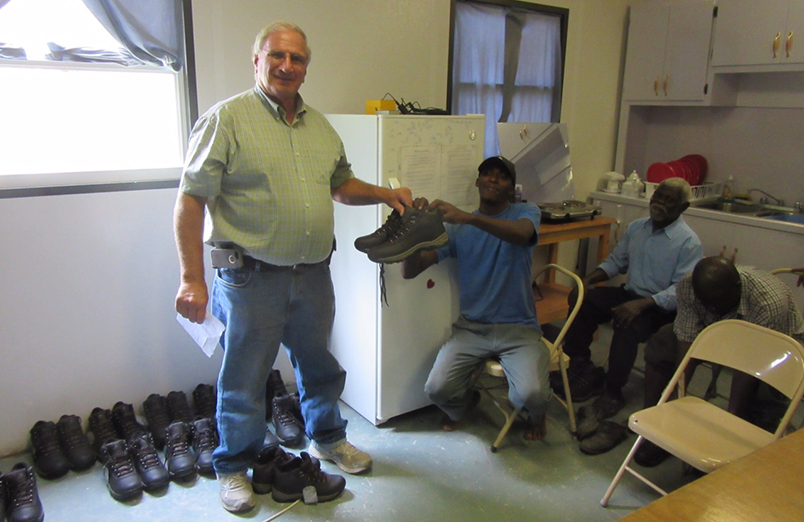 Pastor Carlson giving shoes to Haitians