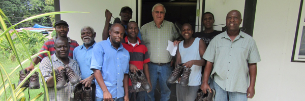 Pastor Carlson with the shoes and Haitians