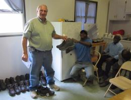 Pastor Carlson giving shoes to Haitians